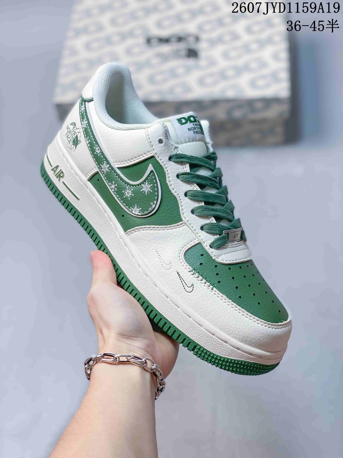 Angled side view showing the white and green sneaker, AIR heel branding, patterned side accent, and green outsole.