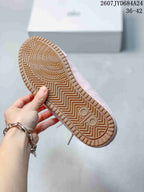Close-up of the sneaker's tan outsole showing a geometric herringbone tread pattern.