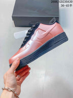 Side view of a coral-pink low-top sneaker with a dark midsole and side Swoosh; image overlay states EU sizes 36–45.5.