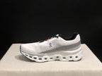 Side view of a white and silver On Cloudmonster 2 shoe