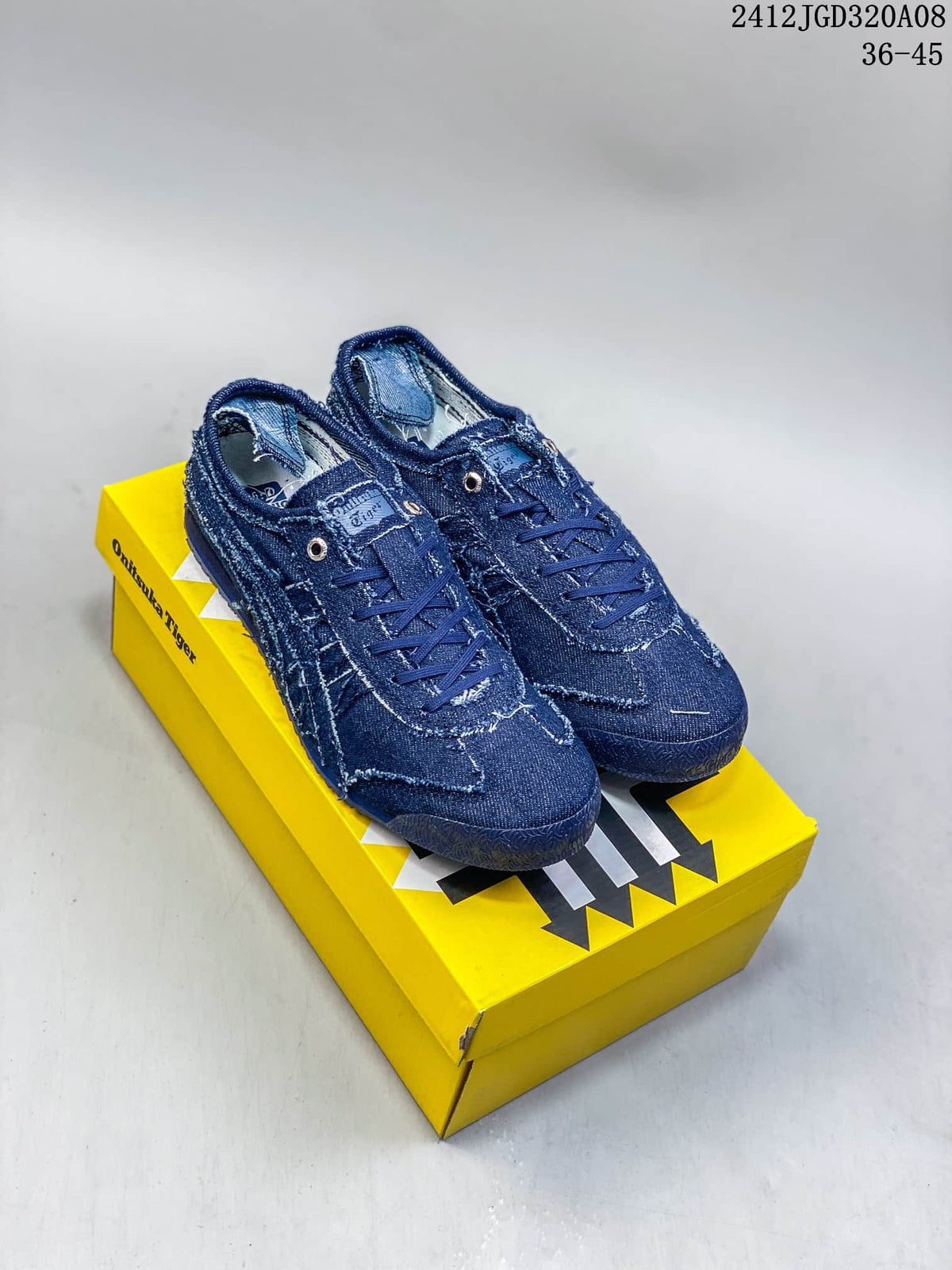 Pair of blue denim-style low-top sneakers displayed on a yellow Onitsuka Tiger shoebox.