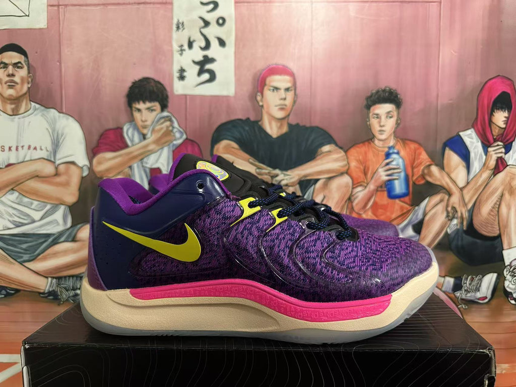 Side view of a purple and navy Nike basketball shoe with a yellow Swoosh and pink accent.