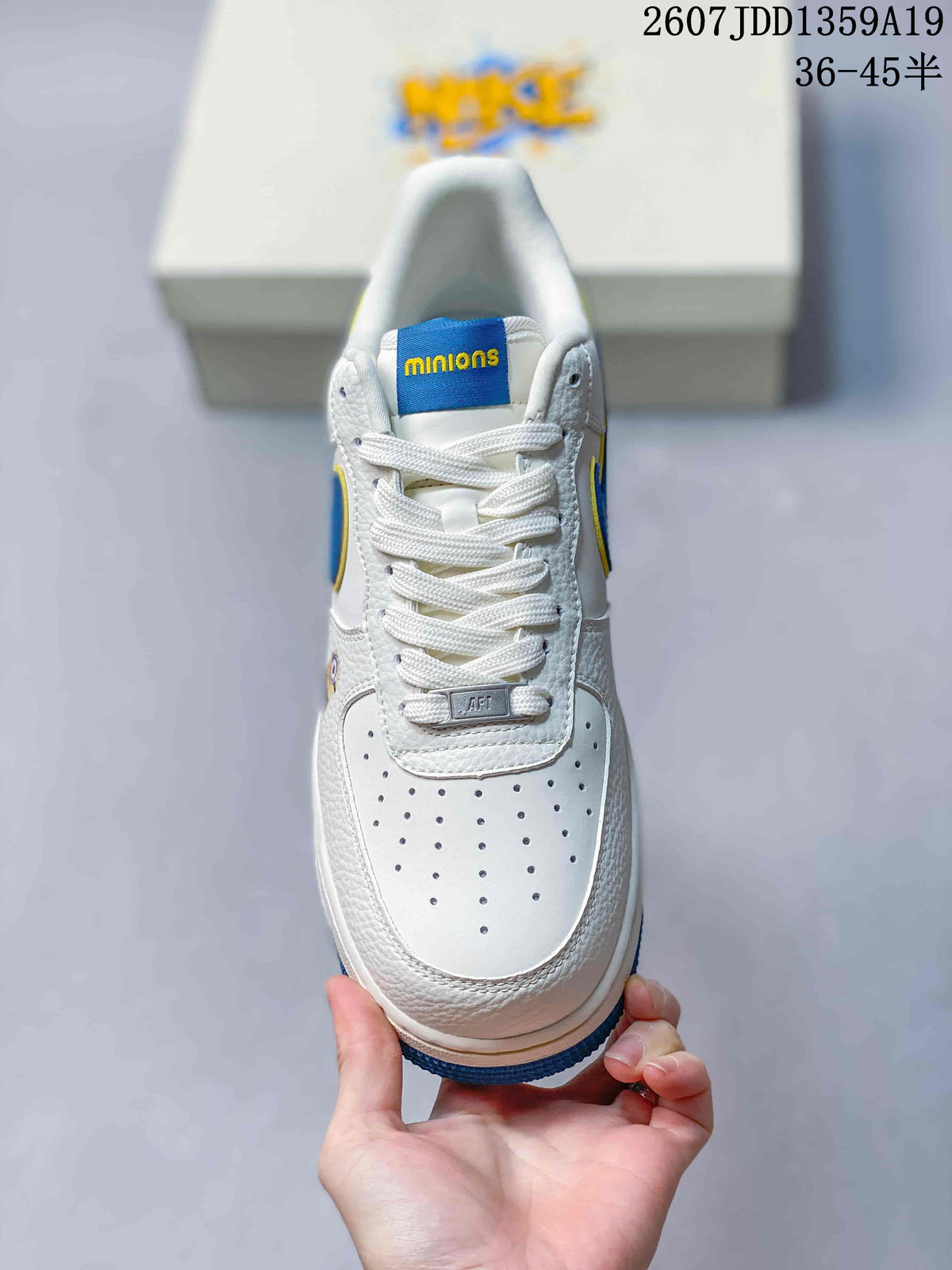 Top view showing the white laces, perforated toe box, blue tongue label and Minions branding.