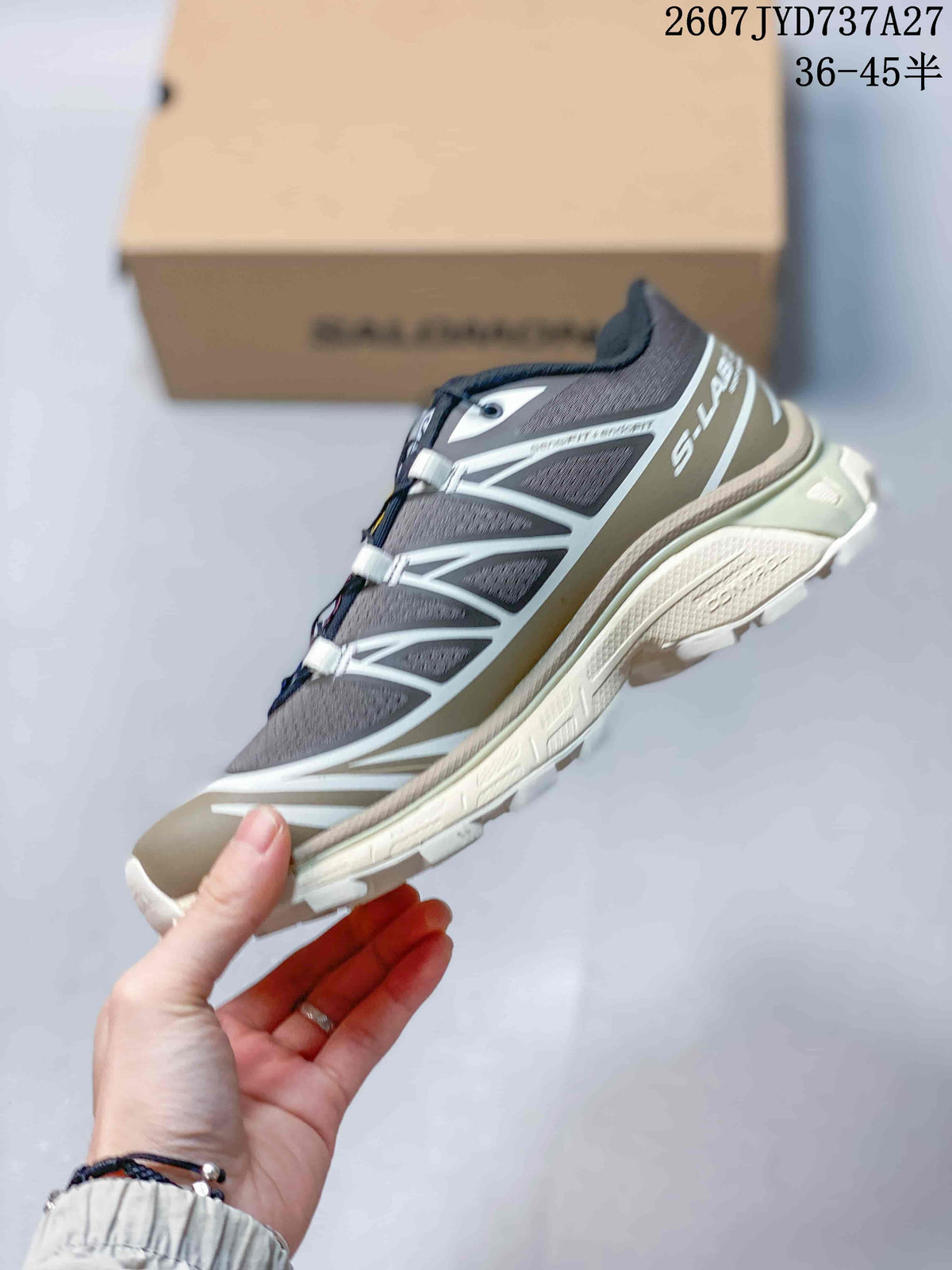 Side profile showing the gray mesh upper, contrasting overlays, low-top shape, and lugged outsole.