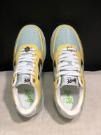 Top view of the BAPE STA sneakers showing white laces, perforated light blue toe panels, and branded insoles.