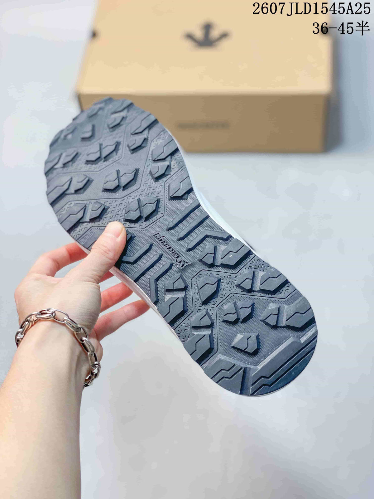 Close-up of the patterned dark outsole showing directional tread blocks.