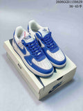 Pair of white and blue low-top sneakers with The North Face branding on the tongues, displayed on a shoe box.