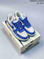 Pair of white and blue low-top sneakers with The North Face branding on the tongues, displayed on a shoe box.