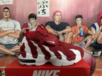 Side view of a red and white Nike basketball-style sneaker showing layered panels, ventilation openings, and a visible heel window.
