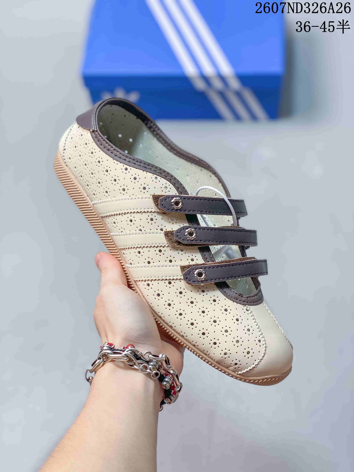 Angled side view highlighting the perforated cream upper, brown trim and three strap closures.