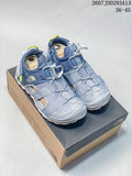 Pair of blue-gray The North Face outdoor sandals displayed on a branded shoe box.