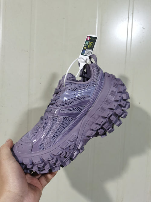 Close angled view of the faded purple mesh sneaker showing its layered upper and chunky lugged outsole.