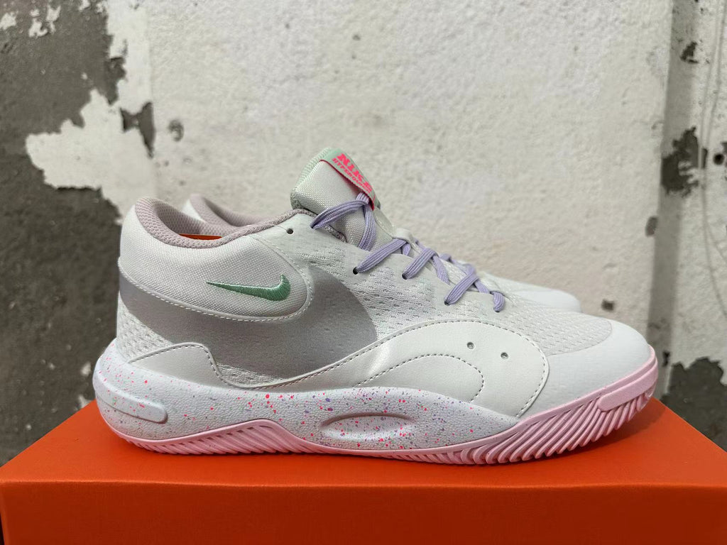 Side view of a white Nike basketball shoe with a mint-green Swoosh and speckled midsole