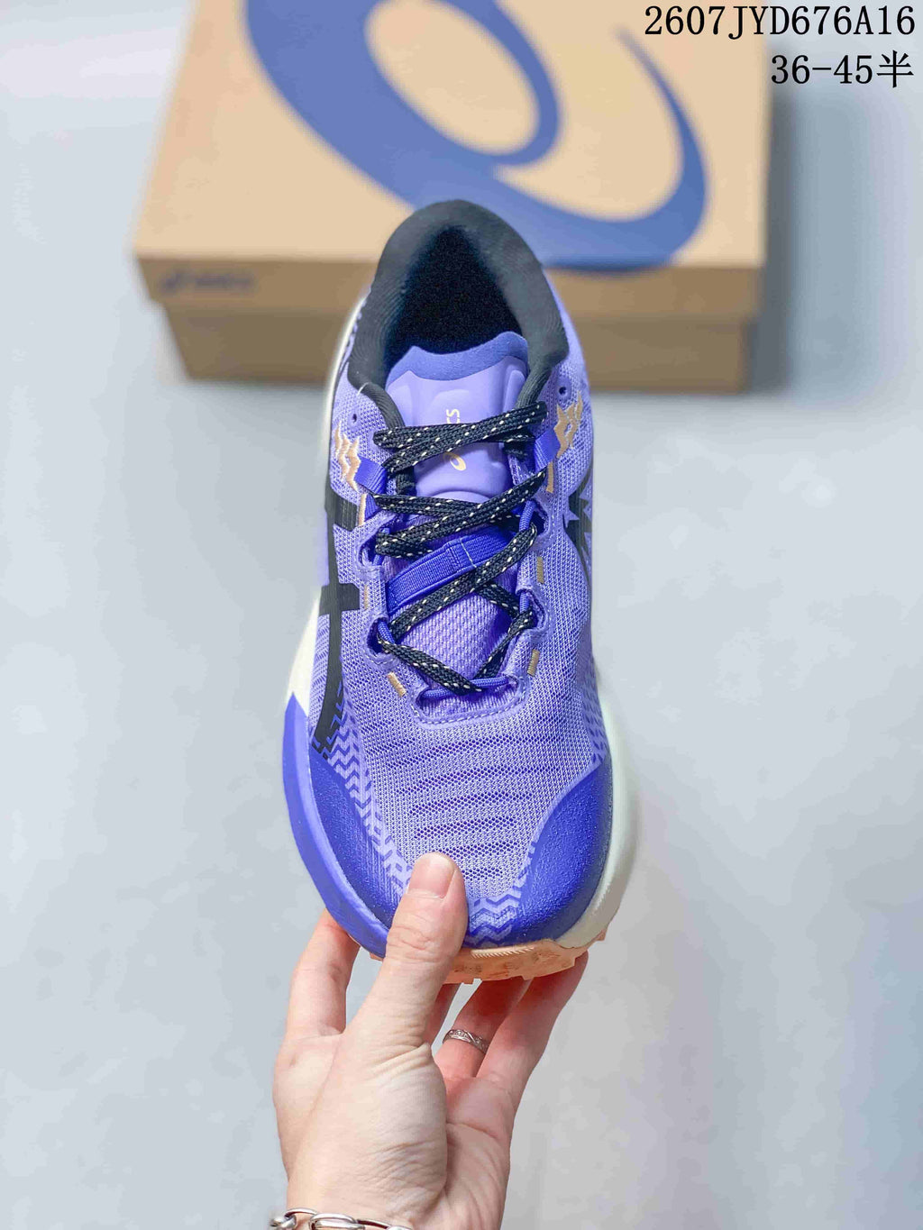 Top view showing the mesh toe box, black laces, padded tongue and purple-blue color blocking.