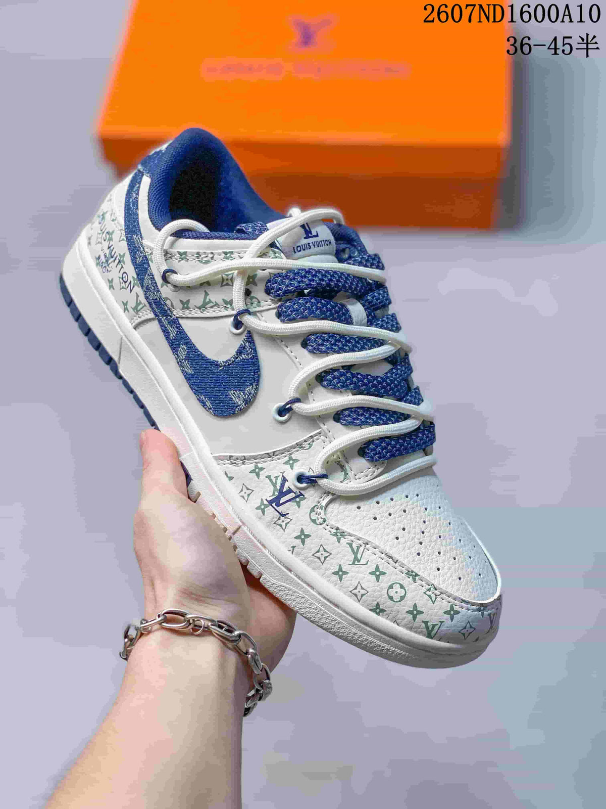Angled side view showing the white and blue sneaker, blue Swoosh and monogram-style upper graphics.