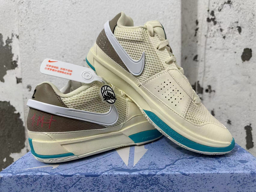 Nike Ja 1 shoes displayed together, showing the cream upper, white Swoosh, and teal details