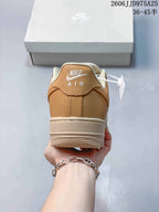 Rear view of the tan and cream sneaker showing the padded heel collar, stitched heel panel, and cream midsole.