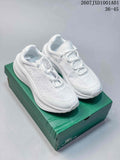 Pair of white Lacoste lace-up sneakers shown on a green shoe box