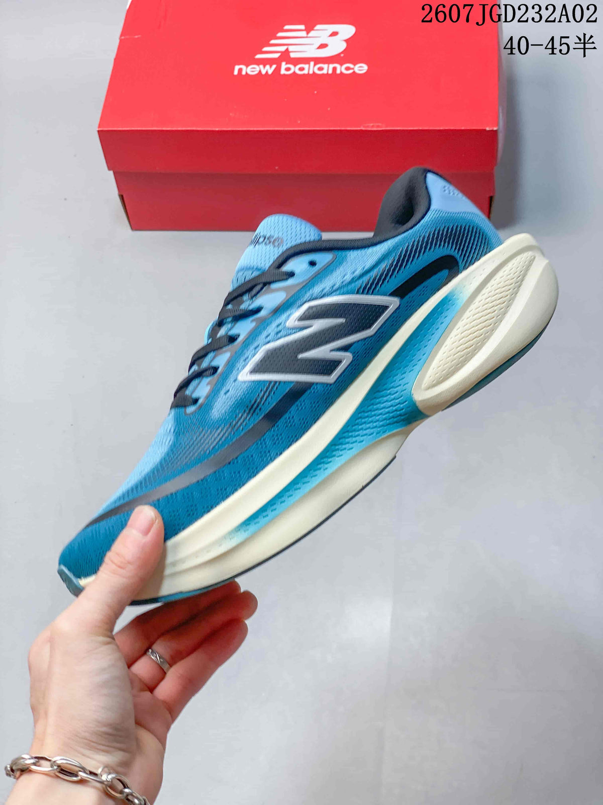 Side view of a blue New Balance Ellipse running shoe with a large N logo