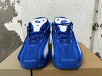 Top view of blue Nike sneakers with white tongue details and lace-up fronts