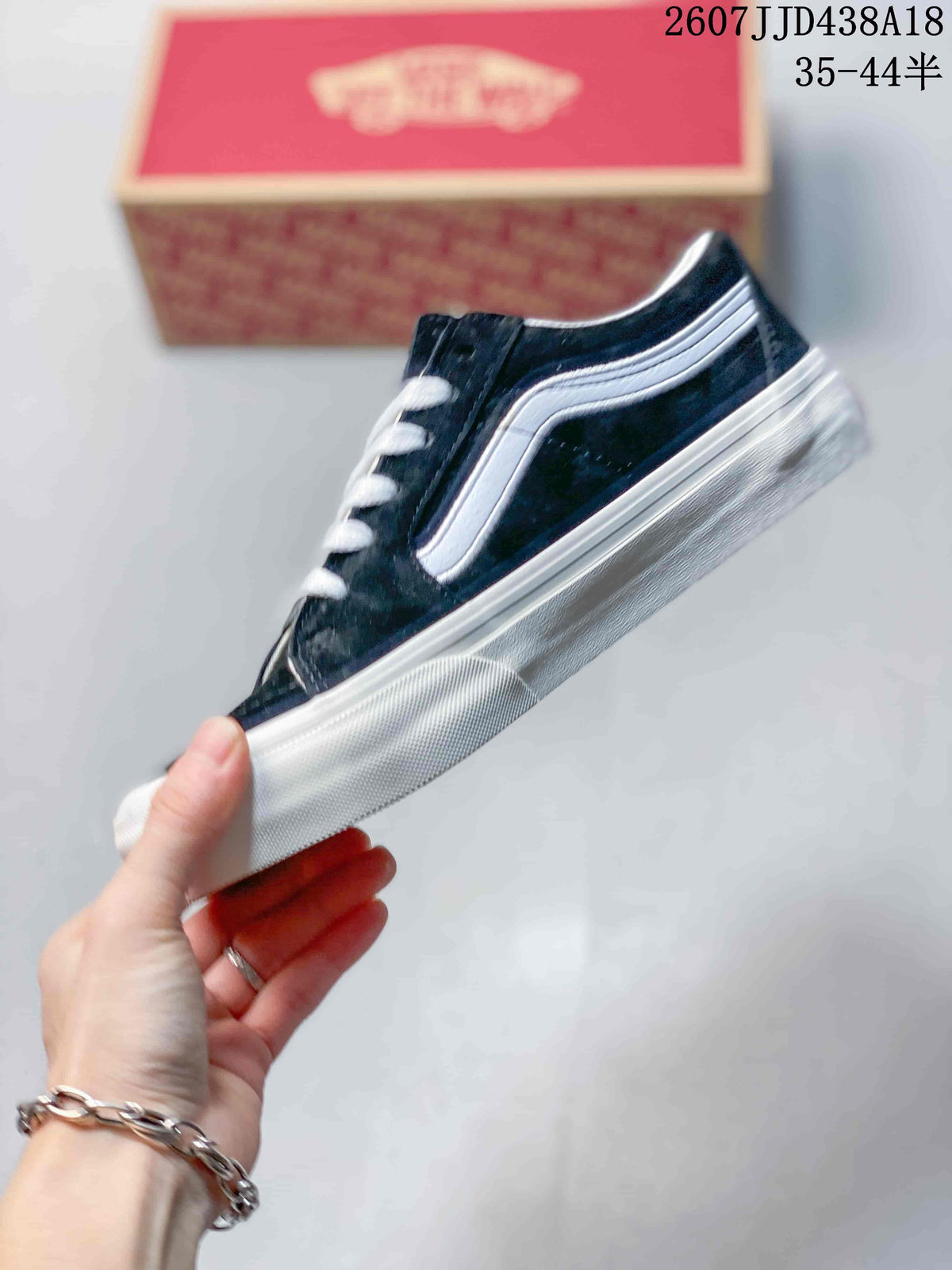 Side profile of the black low-top sneaker with a white side stripe, white midsole, and lace-up construction.