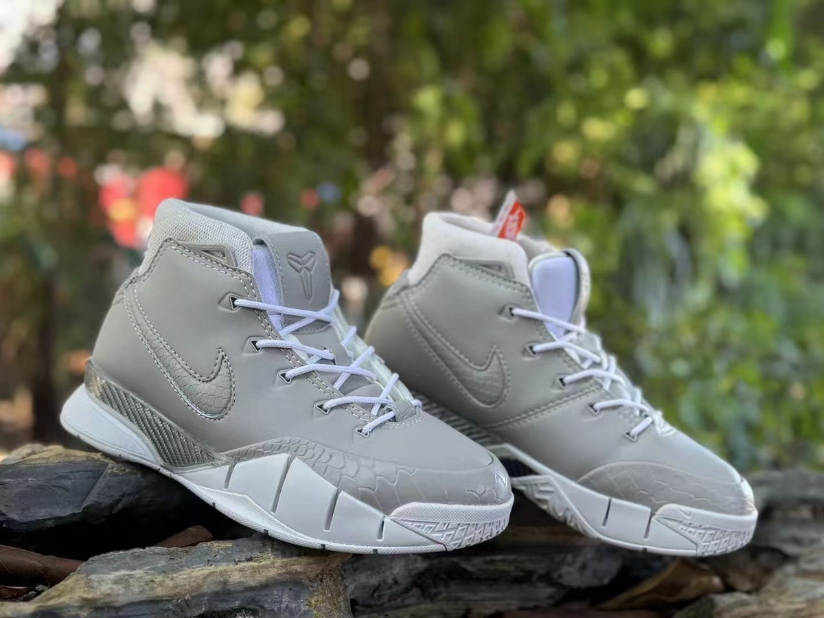 Pair of grey high-top basketball shoes shown from the front side