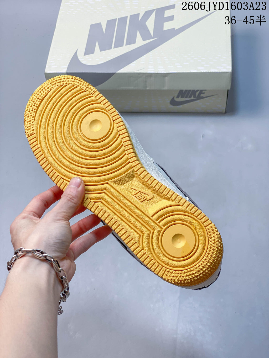 Close-up of the sneaker's gum-yellow outsole with circular tread details.