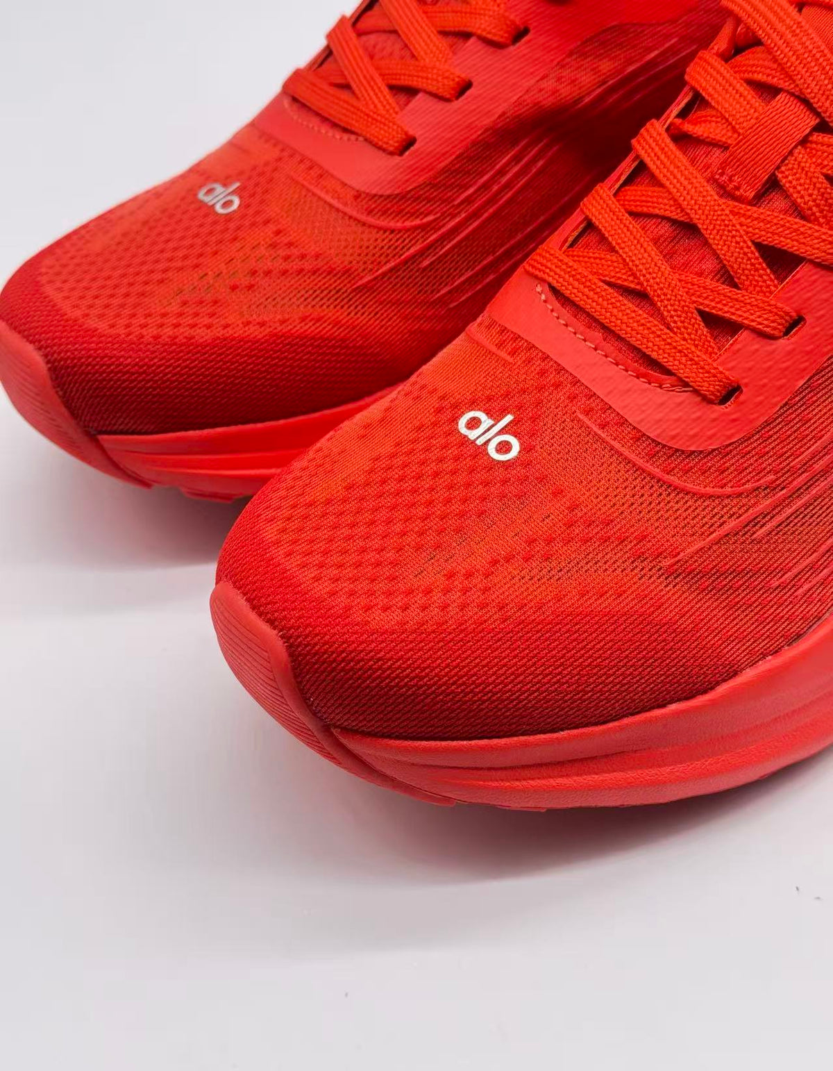 Close-up of the red textured toe boxes, laces, and alo branding.