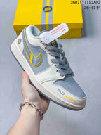 Close side view of a gray and white sneaker with yellow-trimmed side logo and SU7 Ultra lettering