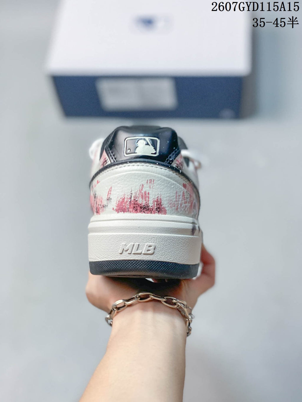 Rear view of the sneaker showing distressed pink graphics, a dark heel tab and MLB branding on the midsole.