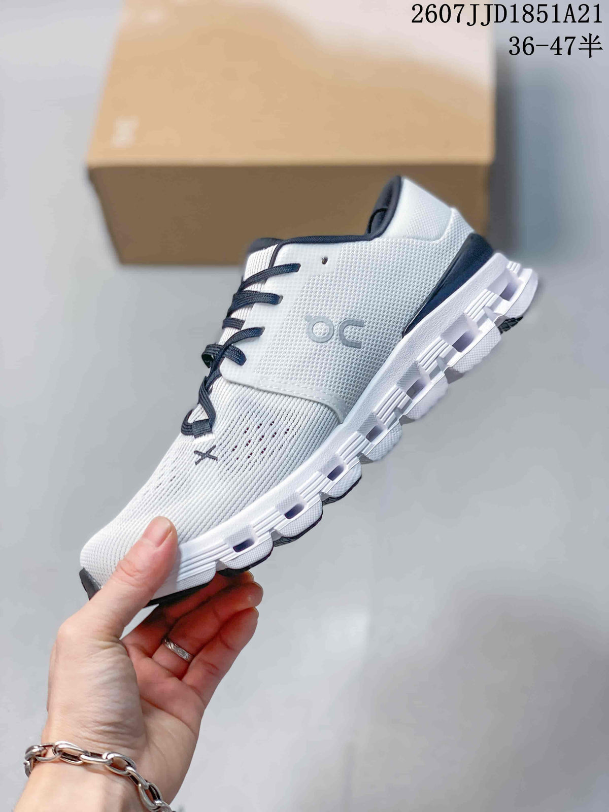 Side profile of the white low-top sneaker showing the knit-style upper, On side branding, laces, and segmented sole.