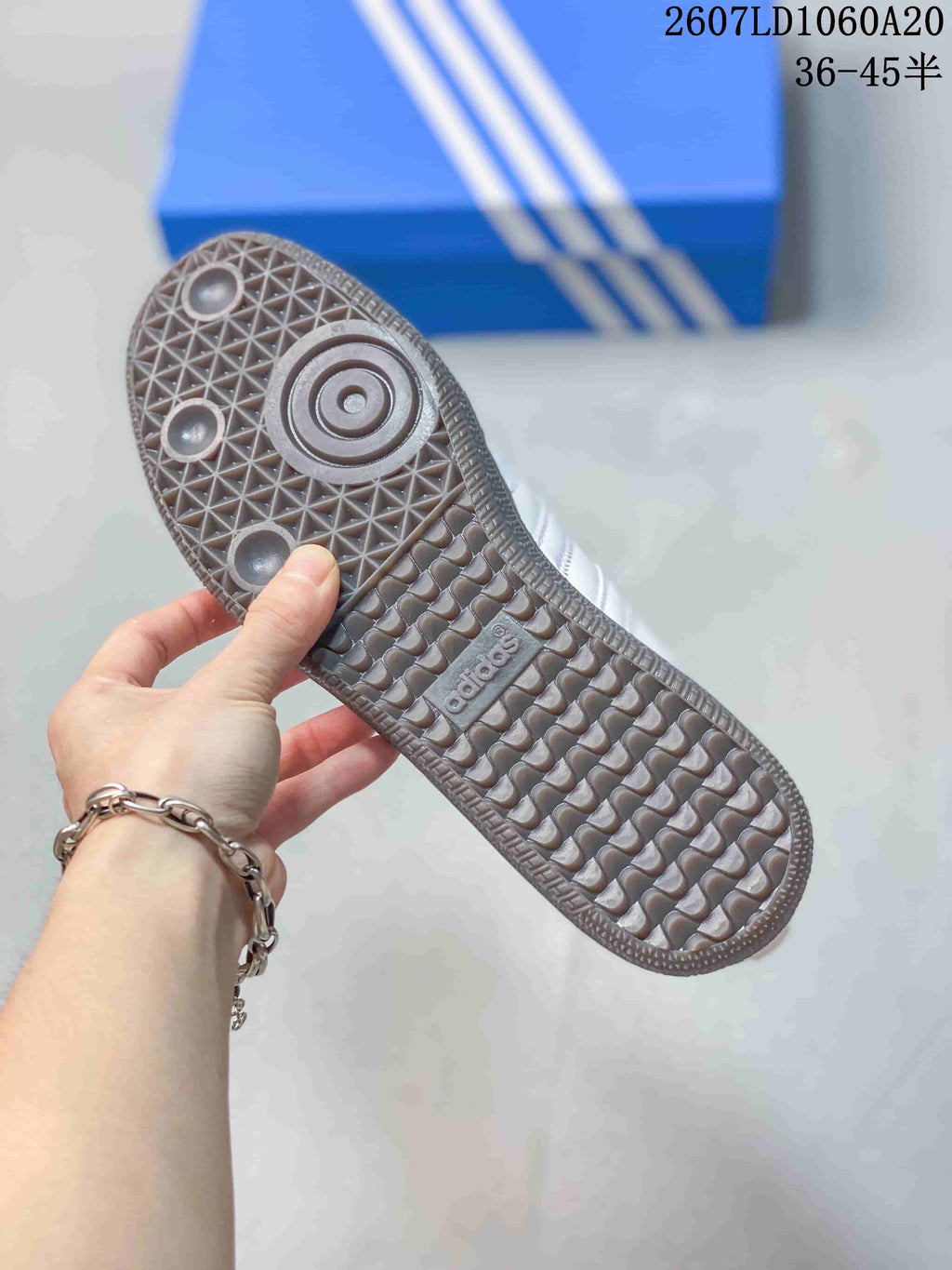 Close-up of the sneaker outsole showing a gum-colored geometric tread pattern.