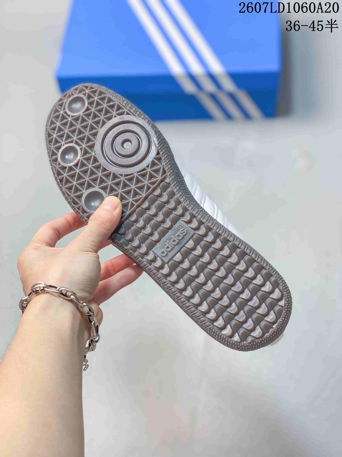 Close-up of the sneaker outsole showing a gum-colored geometric tread pattern.