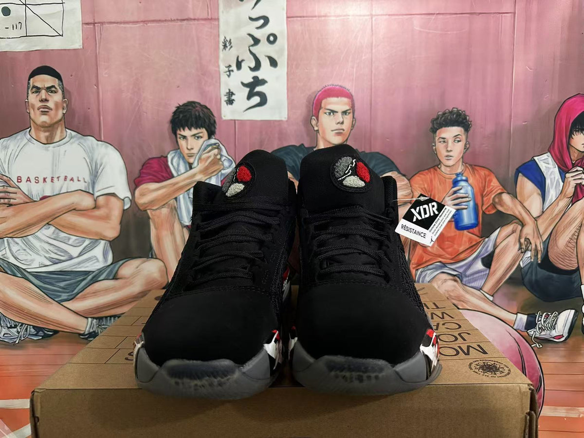 Front view of black Jordan 23 basketball sneakers with red, white, and gray details.