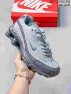 Angled side view of the silver and gray sneaker with its column-shaped heel