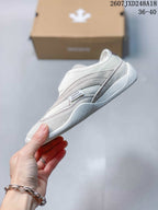 Side view of the white low-top sneaker showing layered panels, stitching, and the low-profile sole; the image shows the code 2607JXD248A18 and size range 36–40.