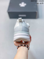 Rear view showing the padded heel, pull tab, layered midsole, and DESCENTE branding.