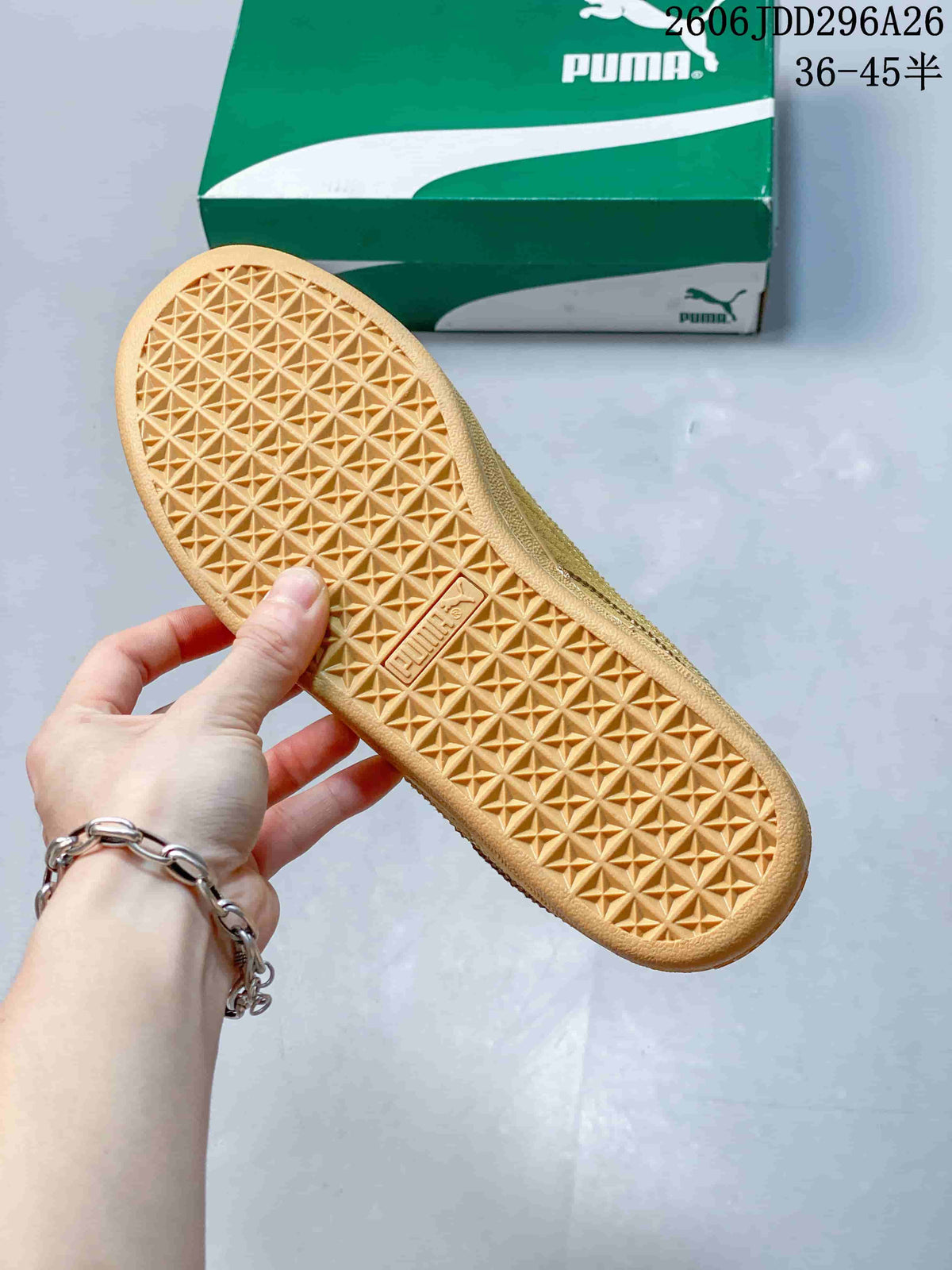 Close view of the wheat-colored sneaker outsole showing a repeating geometric tread pattern and PUMA branding.