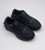 Top three-quarter view of a pair of black Alo sneakers showing the laces, tongue logos, and rounded toe boxes.