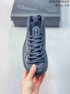 Front view of the gray shoe showing its laces and tongue detail