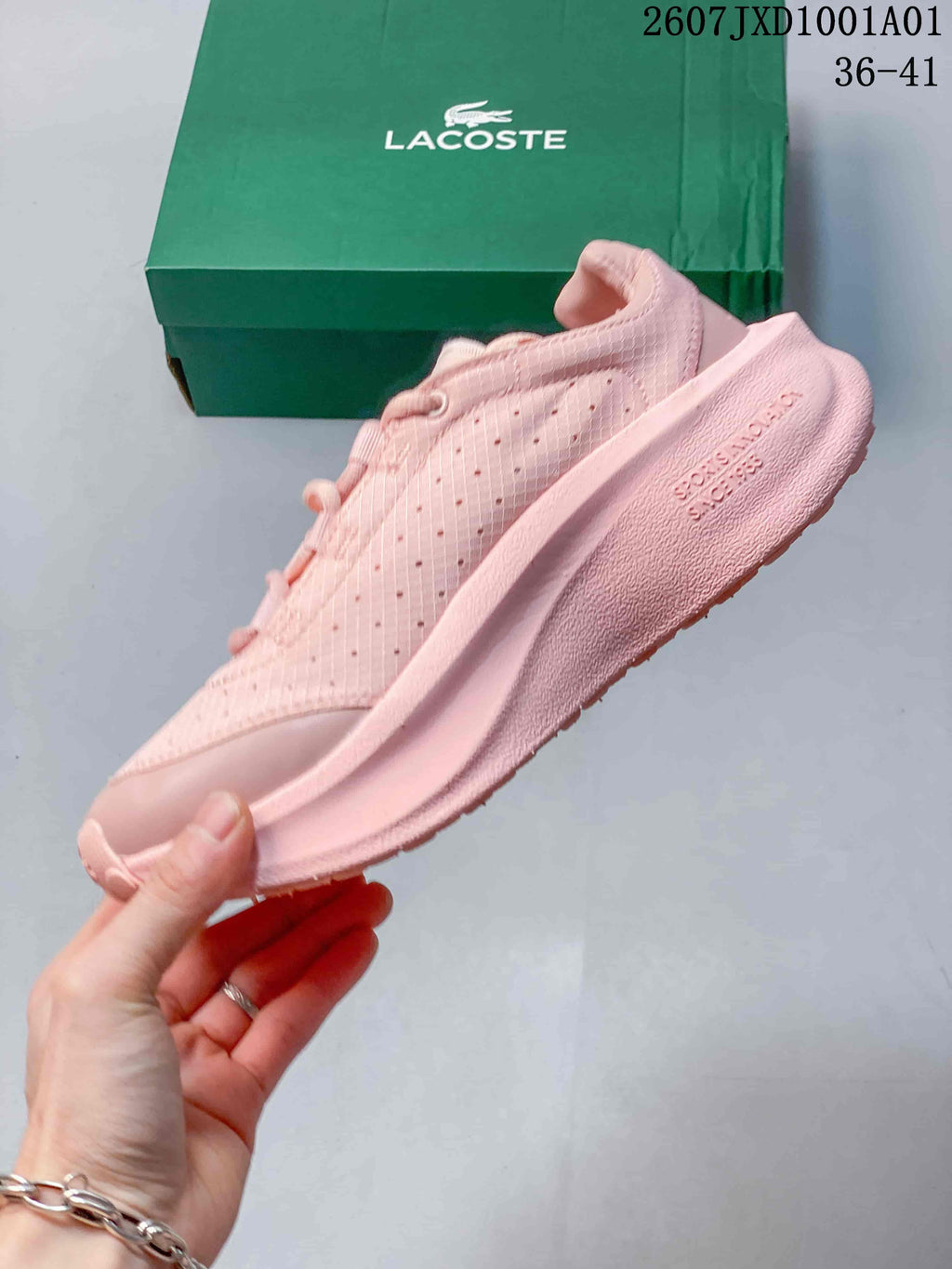 Side view of a pink sneaker with a thick molded sole