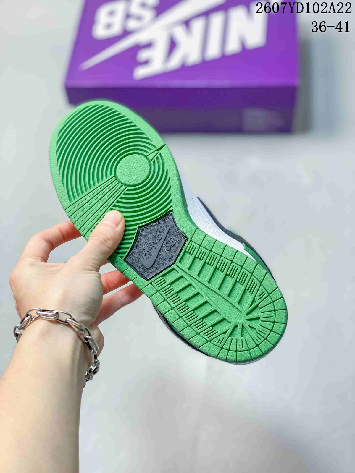 Underside view showing the green circular-pattern outsole and dark Nike SB outsole insert.