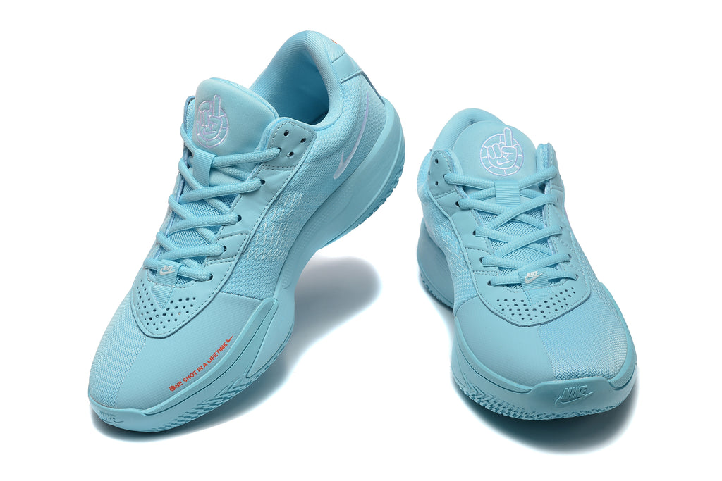 Pair of light-blue Nike G.T. Cut Academy basketball shoes shown from front and angled views