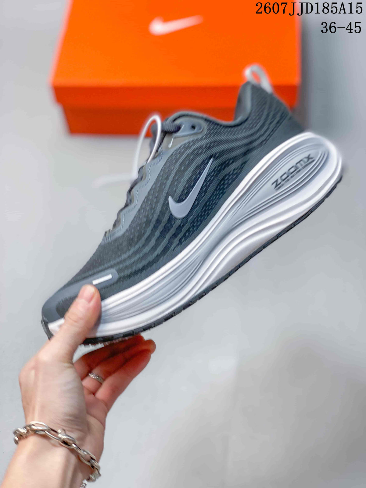 Side view showing the gray textile-style upper, Swoosh branding, and sculpted white midsole.