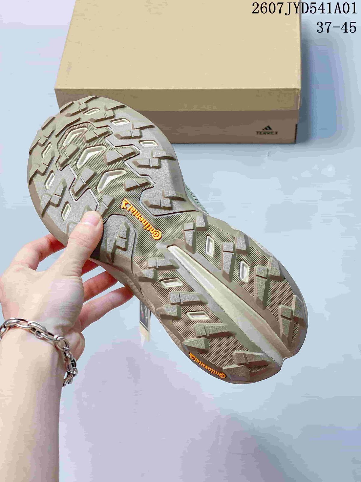 Close-up of the lugged outsole on the beige Terrex shoe