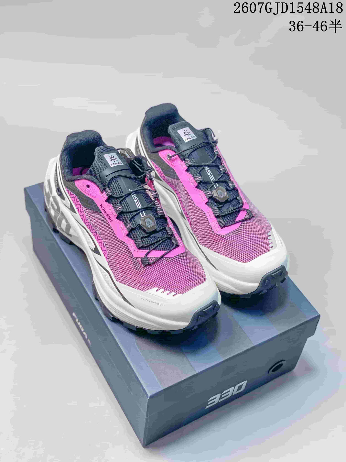 Pair of pink, white and black Kailas FUGA DU 2 trail running shoes shown on a shoebox.