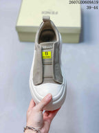 Top view of the sneaker showing the elasticated opening, tongue label, and white rounded toe.