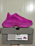Side profile of the purple sneaker displayed on its shoe box; the box label shows Triple S, style code 524039 W2FA1 9016, color Joint Purple Red, and size C 39.