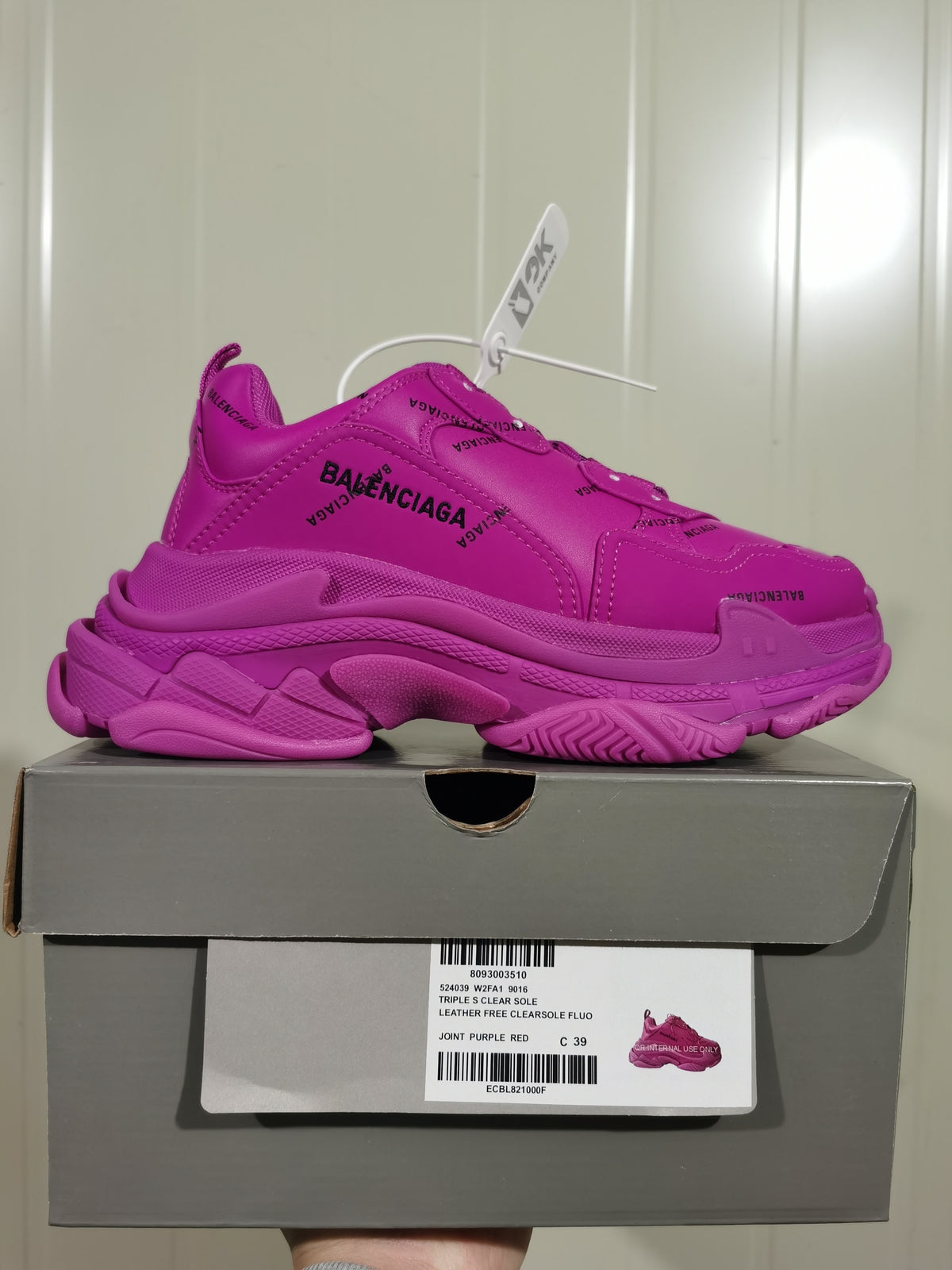 Side profile of the purple sneaker displayed on its shoe box; the box label shows Triple S, style code 524039 W2FA1 9016, color Joint Purple Red, and size C 39.