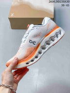 Side view of a white and orange On Cloudtilt sneaker